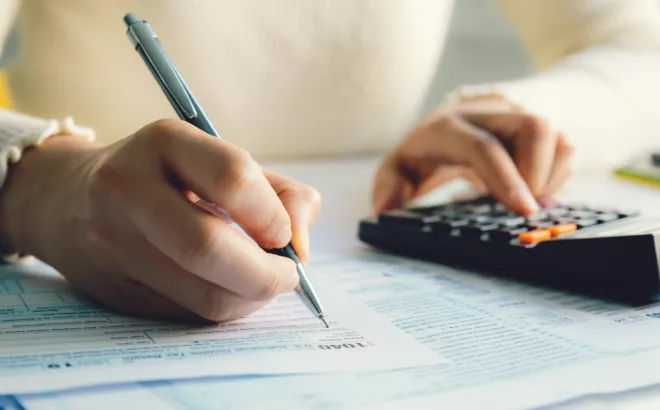 Een jonge persoon die de belasting van een studentenjob berekent